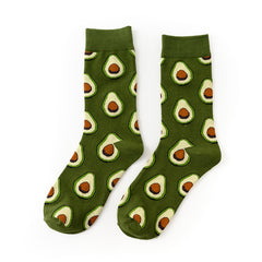 Pair of Green Avocado crew socks with avocado halves on a green background