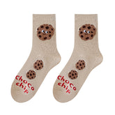Pair of beige crew socks with smiling chocolate chip cookies and red Choco chip lettering