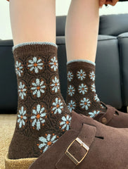 All-over Floral style brown crew socks with pale blue flower motifs and blue cuff edging
