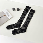 Pure Black long floral lace socks displayed as a pair on a pale background