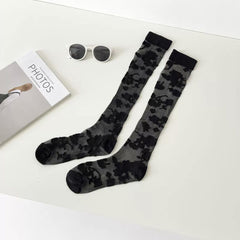 Pure Black long floral lace socks displayed as a pair on a pale background