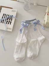 White knit ankle socks with blue gingham bow details, light blue cuffs and small bow motifs