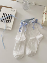 White knit ankle socks with blue gingham bow details, light blue cuffs and small bow motifs