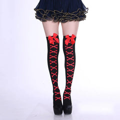 Black over-knee socks with red crossbones and red cuff bows, styled with platform shoes