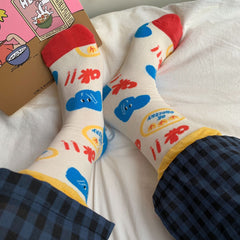 Cream crew socks with blue elephant faces, red lettering, yellow cuffs and red toes