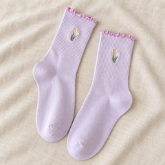 AI flat product illustration of a Lavender tulip-embroidered matching sock pair on oat linen.