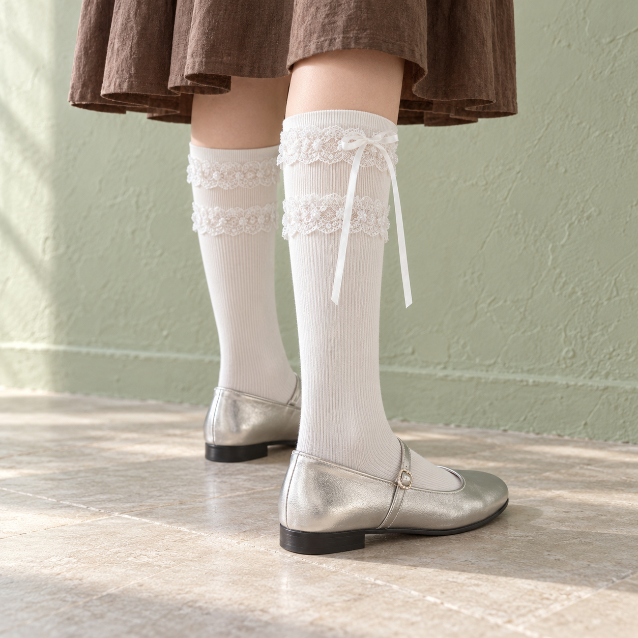 AI styling illustration of White long ribbed socks with two lace bands and upper ribbon tails, worn with silver closed shoes against a pale green wall.