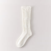 White long sock with three leaf pointelle sections, two broad textured bands and a geometric knit cuff