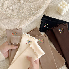 Hand-held display of bow-embroidered ribbed socks; offered Black is upper right and Dark Coffee below it; other colors are reference only