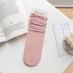 Peach Pink socks with small floral openwork and a rippled cuff edge