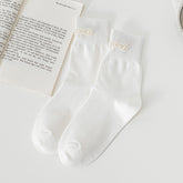 White Pearl Style Flowers socks with flower-shaped bead decorations near the cuffs