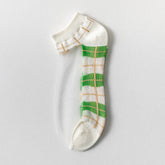 Green Plaid sheer ankle sock with green blocks, tan grid lines, light trim and a transparent side panel