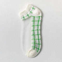 White Plaid sheer ankle sock with green checks on a light background, light trim and a transparent side panel
