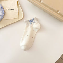 Khaki Dot style ivory ankle sock with sparse khaki dots, a ribbed cuff and gingham bow.