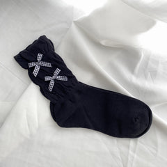 Black ruched sock with two black gingham bows arranged vertically