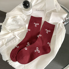Burgundy Bows socks with pale bow motifs and straight cuffs