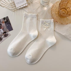 White Double Bow ankle socks with narrow knitted bobble cuffs and two small ribbon bows shown on one sock