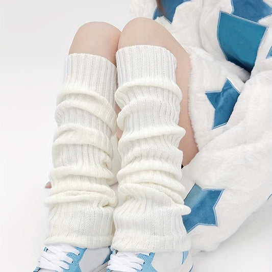 White ribbed knit leg warmers gathered above white and blue sneakers