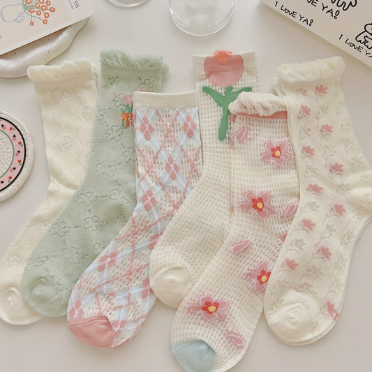Pastel mesh socks with floral, tulip and diamond motifs laid flat