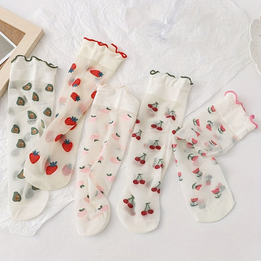 Five fruit-print sheer sock designs laid flat with red, green and pink ruffled cuffs