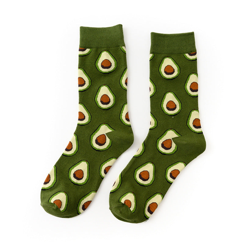 Pair of Green Avocado crew socks with avocado halves on a green background