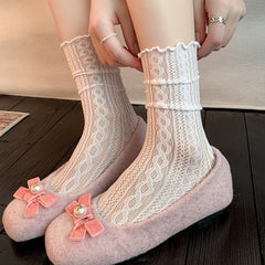 Cream cable-pattern mesh crew socks with ruffled cuffs, worn with pink flats