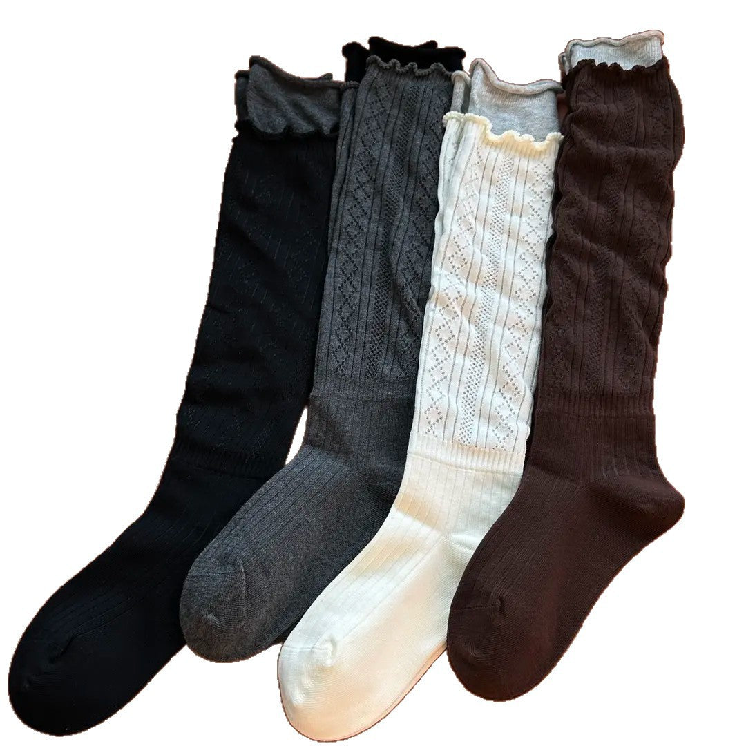 Long socks in a group flatlay; Gray is second from left. Coffee at right is not offered; purchase is one selected pair