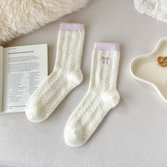 Pink Trim cream crew socks with fuzzy diamond texture, pink cuffs and embroidered bow in a flat lay