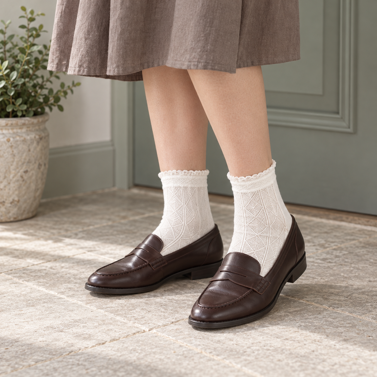 AI styling illustration of White diamond-pattern frilled-cuff socks with dark brown loafers in a sage-grey entryway.