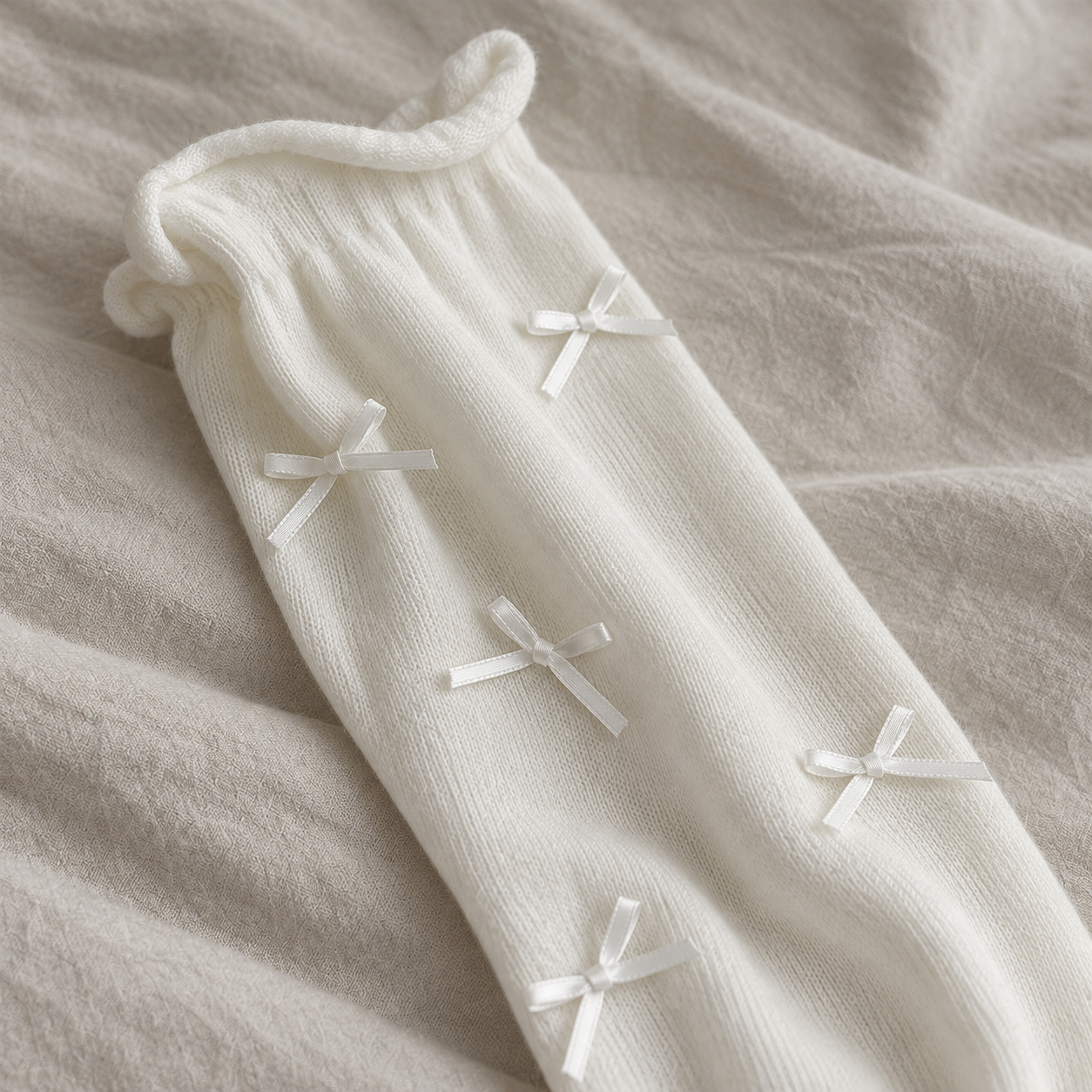 AI close detail illustration of the rolled rim and small satin ribbon bows on a white long sock