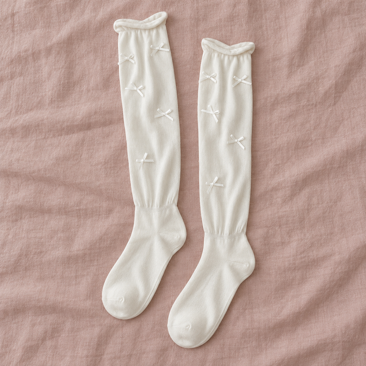 AI overhead pair illustration of white long ribbon-bow socks arranged vertically on muted rose linen
