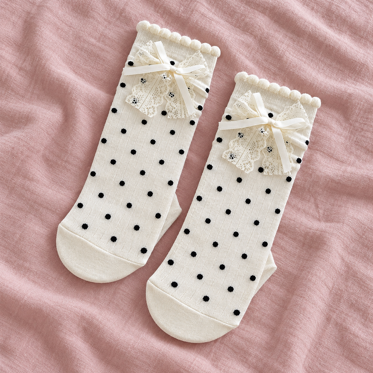 AI folded-pair illustration of opaque white black-dot socks with layered white lace and ribbon bows
