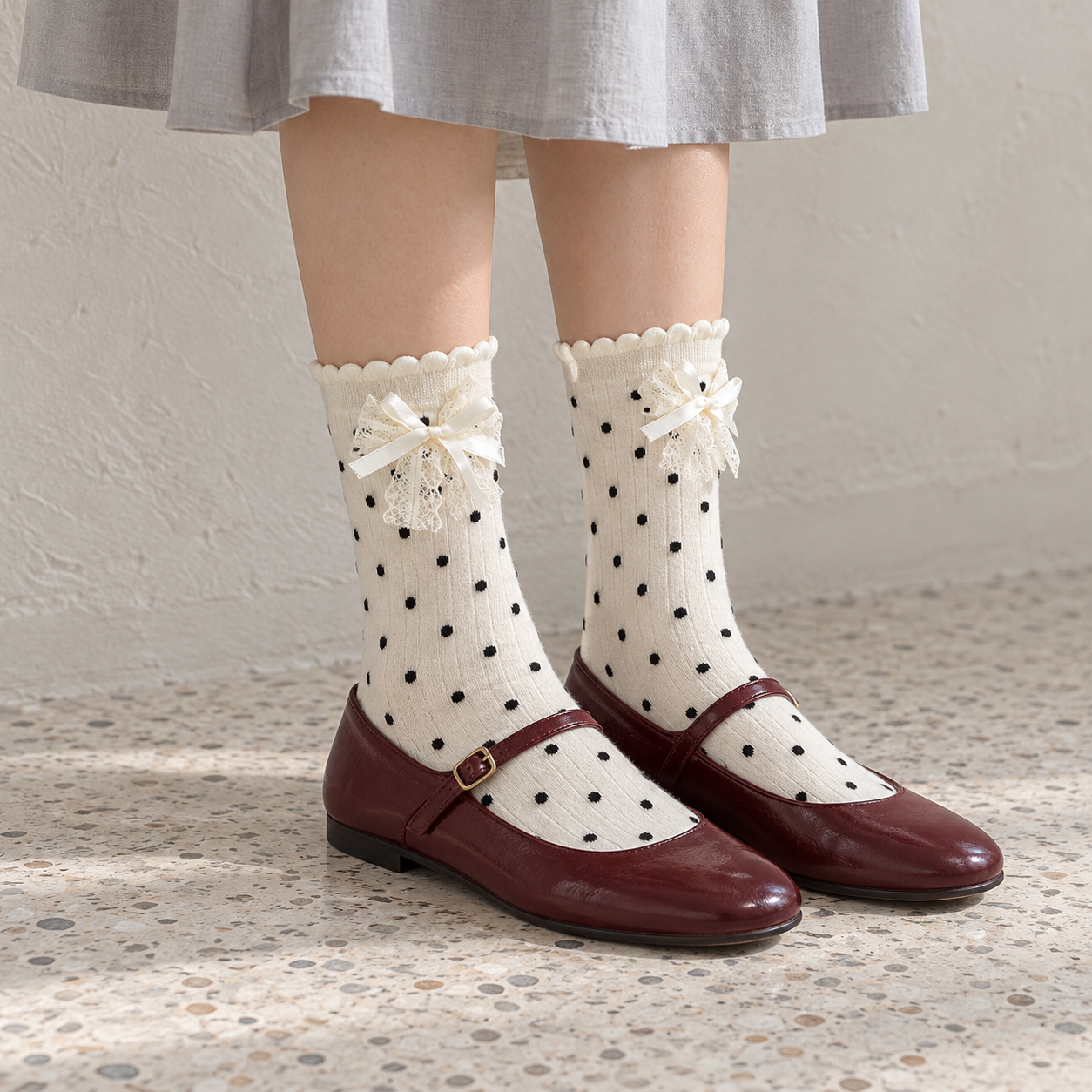 AI side styling illustration of white polka-dot lace-bow socks with burgundy flats beside a gray wall
