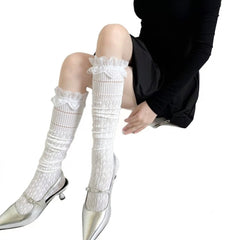 White long socks with diamond openwork, eyelet bands and flared scalloped lace cuffs, styled with silver shoes