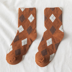 Pair of Brown diamond-pattern crew socks with white diamonds and fine dotted lines