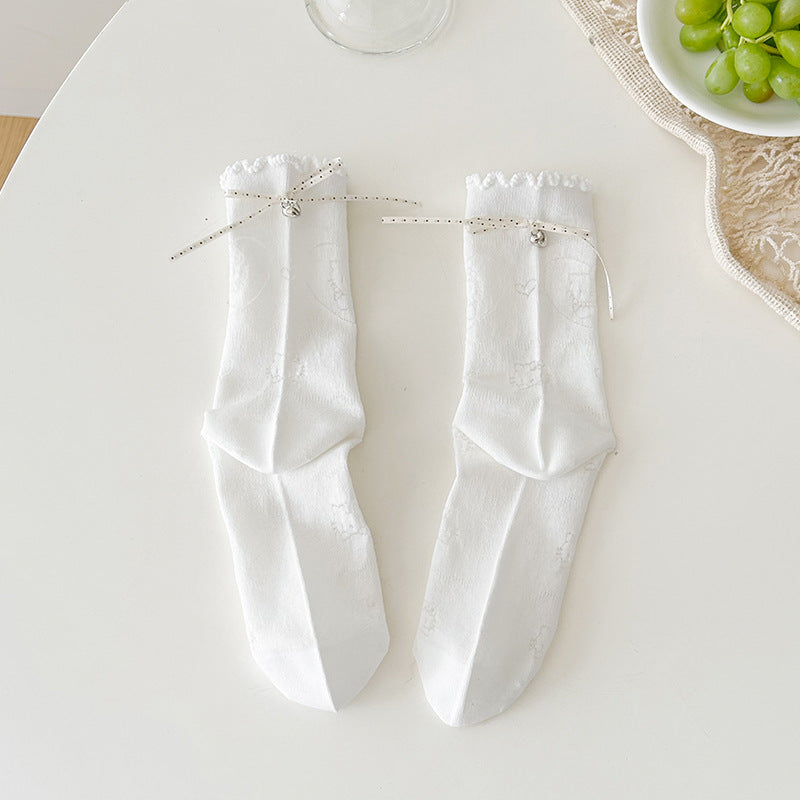 White floral crew socks with tonal flower outlines, dotted ribbon bows and ruffled cuffs