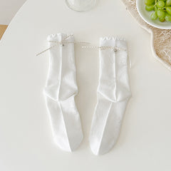 White floral crew socks with tonal flower outlines, dotted ribbon bows and ruffled cuffs