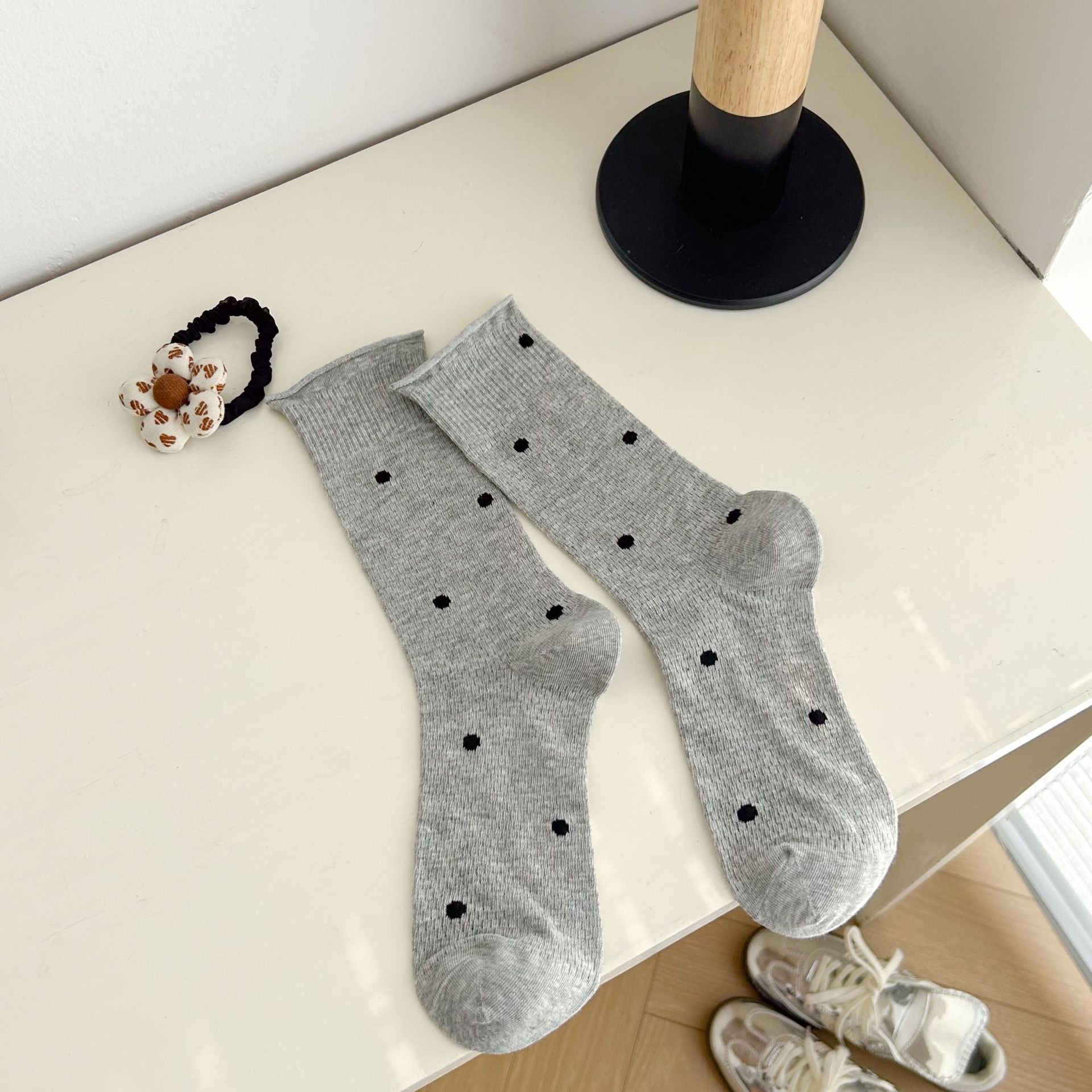 Gray dotted socks with rolled cuff edges