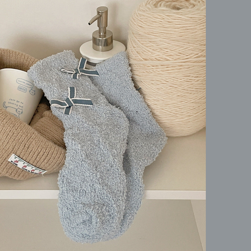 Blue Gray fuzzy-looking crew socks with dark blue bows and pale edging