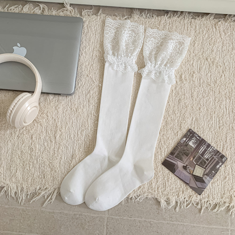 White long socks laid flat with broad gathered floral lace cuffs and plain bodies