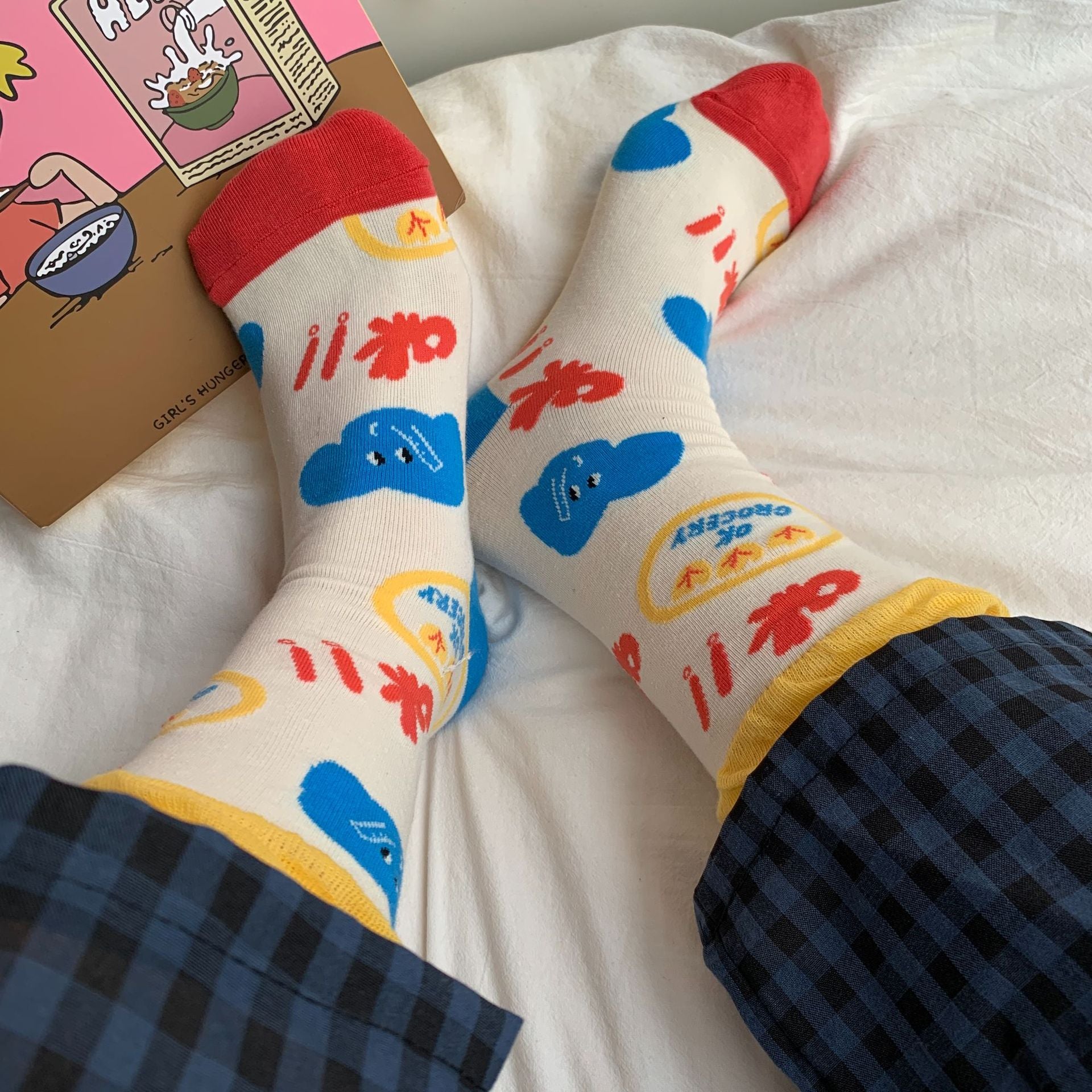 Cream crew socks with blue elephant faces, red lettering, yellow cuffs and red toes