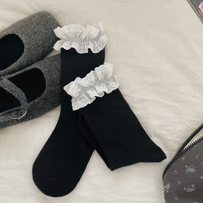 Black crew socks with white heart-patterned lace cuffs, selected one-pair option