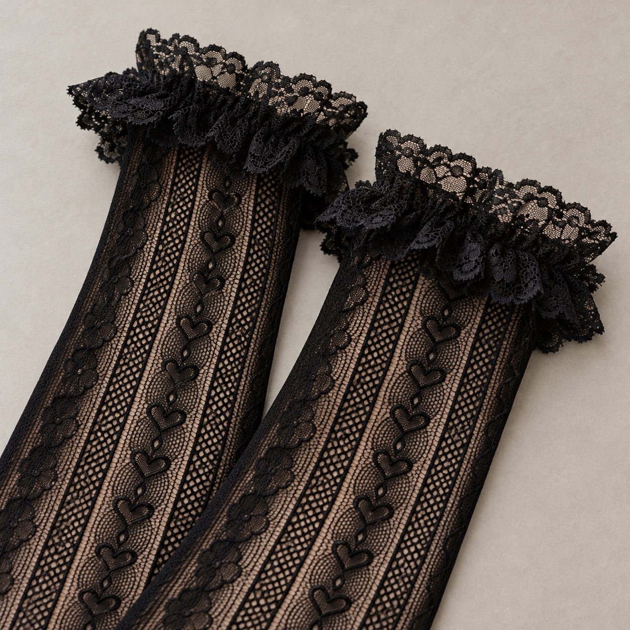 AI closer product view of the gathered floral lace openings and upper heart-link mesh columns on Black long socks.