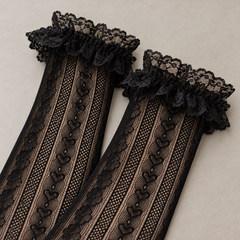 AI closer product view of the gathered floral lace openings and upper heart-link mesh columns on Black long socks.