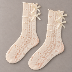 AI complete-pair illustration of Milky White pointelle socks with narrow waved cuffs and two stacked satin bows on each supported outer side