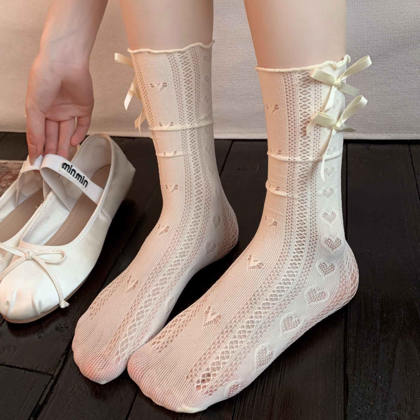 Original supplier reference of a Milky White pair with vertical heart-eyelet columns, ladder-like openwork and two stacked same-color satin bows