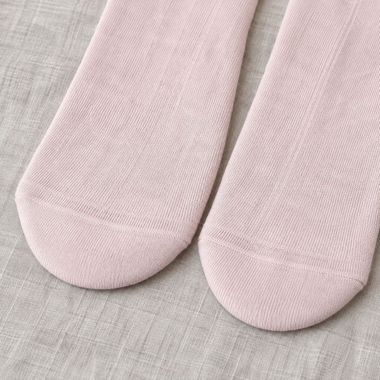 AI close detail illustration of the Light Pink plain rounded toe fronts and fine-knit-looking lower body, with heels and soles out of view