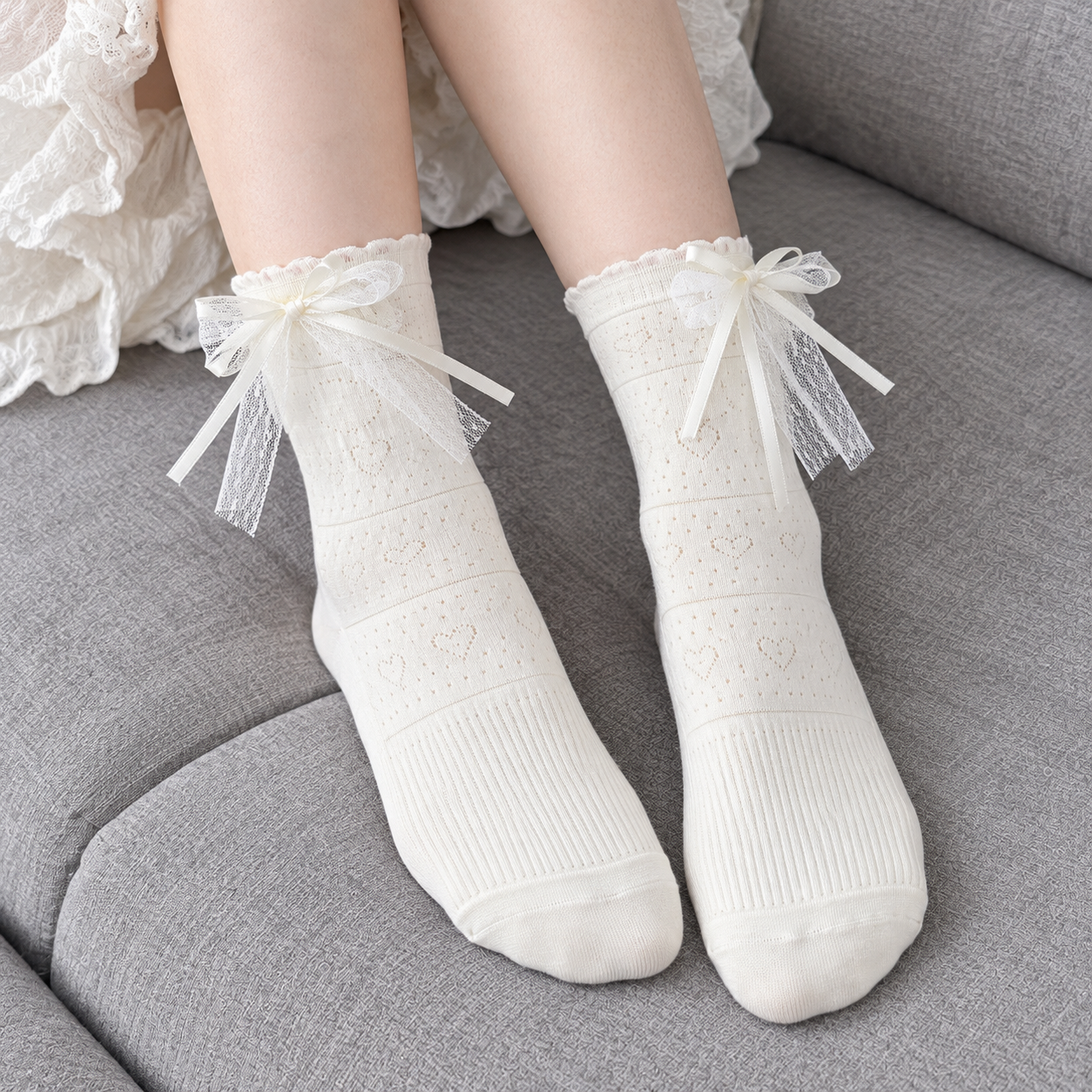 AI supported unshod styling illustration of White heart-pointelle socks with fine horizontal bands, layered bows and plain rounded toes on grey upholstery