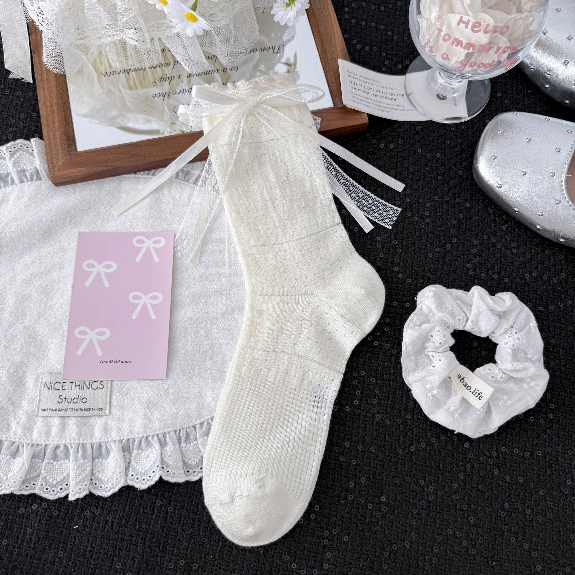 Untouched supplier reference of the selected White sock with tiny heart-like pointelle, fine horizontal bands and layered white mesh-and-ribbon bow near the cuff