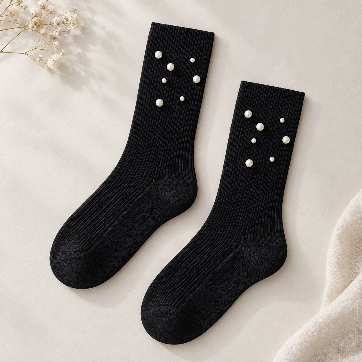 AI product illustration of an empty matching Black fine-rib pair with plain cuffs and seven scattered pearl-style beads on each visible upper panel.